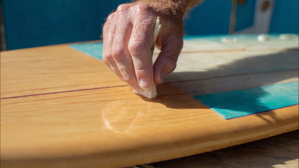 Damaged surfboard tail block showing crack and delamination requiring fiberglass repair