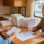 Organized binder containing motorhome maintenance records and service documentation for new RV buyer