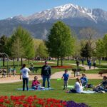 Military families enjoying outdoor activities at Colorado Springs park with Pikes Peak mountain backdrop