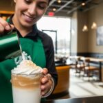 Starbucks barista creating Instagram-worthy seasonal drink with artistic latte design in modern coffee shop setting