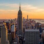 New York City skyline with Empire State Building featured prominently in golden hour light