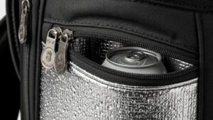 Modern golf bag with insulated cooler pocket open showing cold beverages inside on golf course