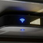 Smart garage door opener mounted on ceiling with WiFi signal indicator showing strong connection strength