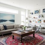 Modern living room featuring clean white walls and contemporary furniture with traditional Persian rug and antique wooden coffee table creating elegant style contrast