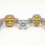 Colorful alternative gemstone engagement rings displayed on white background showing moissanite sapphire and morganite options