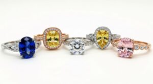 Colorful alternative gemstone engagement rings displayed on white background showing moissanite sapphire and morganite options