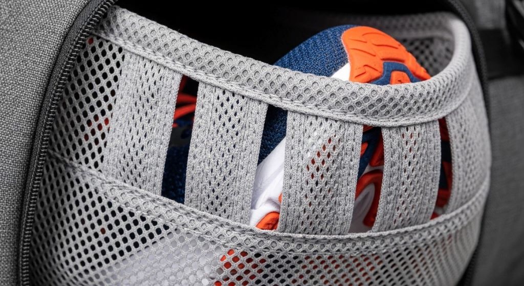 Close-up of breathable mesh shoe compartment in fitness bag showing ventilation panels for odor control and hygiene