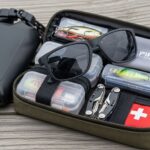 compact fishing sunglasses packed in travel gear kit