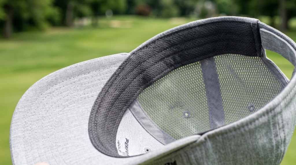 Close-up of a lightweight ventilated golf hat with mesh panels and a moisture-wicking sweatband