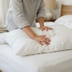 Fluffing pillow filling to remove lumps